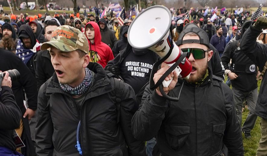 Proud Boys members Zachary Rehl, left, and Ethan Nordean, left, walk toward the U.S. Capitol in Washington, in support of President Donald Trump on Jan. 6, 2021. A federal judge on Tuesday, Dec. 28 refused to dismiss an indictment charging four alleged leaders of the far-right Proud Boys, Ethan Nordean, Joseph Biggs, Zachary Rehl and Charles Donohoe, with conspiring to attack the U.S. Capitol to stop Congress from certifying President Joe Biden&#39;s electoral victory. (AP Photo/Carolyn Kaster, File)