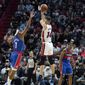 Miami Heat guard Tyler Herro (14) shoots as Washington Wizards guard Jordan Goodwin (9) defends during the first half of an NBA basketball game, Tuesday, Dec. 28, 2021, in Miami. (AP Photo/Lynne Sladky)