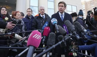 Russian lawyer Ilia Novikov, center right, speaks with media after hearings on the liquidation of Council of Human Rights Center in front of the Moscow Court in Moscow, Russia, Wednesday, Dec. 29, 2021. The Moscow City Court has shut down the Memorial Human Rights Center, sister organization of International Memorial, which was ordered to close Tuesday by Russia&#39;s Supreme Court. (AP Photo/Alexander Zemlianichenko)