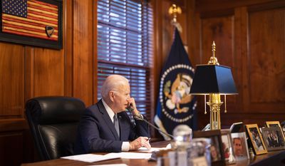In this image provided by The White House, President Joe Biden speaks with Russian President Vladimir Putin on the phone from his private residence in Wilmington, Del., Thursday, Dec. 30, 2021.