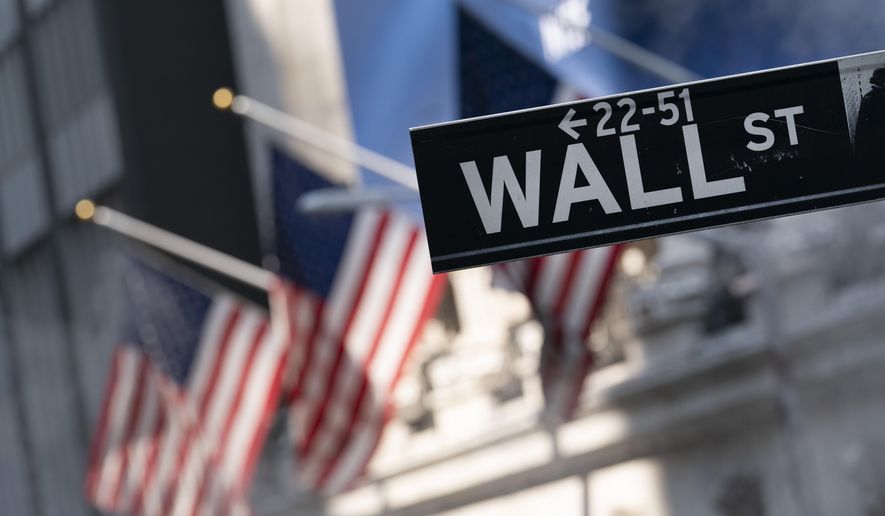 A sign for Wall Street hangs in front of the New York Stock Exchange, July 8, 2021. (AP Photo/Mark Lennihan, file)