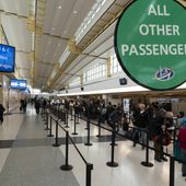 Passengers line up at the TSA security checkpoint at Ronald Reagan Washington National Airport, Wednesday, Dec. 29, 2021, in Arlington, Va. (AP Photo/Alex Brandon) ** FILE **