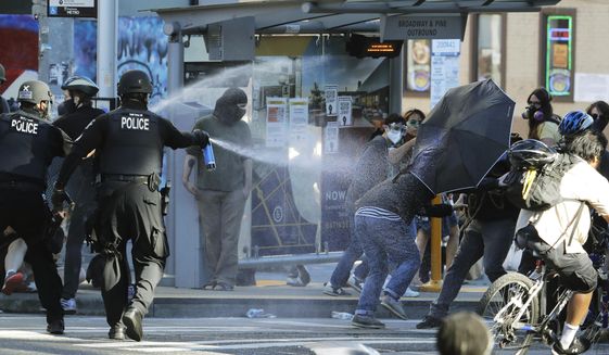 In this July 25, 2020, photo, police pepper spray protesters, near Seattle Central College in Seattle, during a march and protest in support of Black Lives Matter. (AP Photo/Ted S. Warren) **FILE**