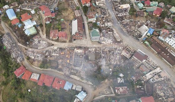 In this aerial photo released by the Chin Human Rights Organization, fires destroy numerous buildings in the town of Thantlang in Chin State in northwest Myanmar, on Dec. 4, 2021. More than 580 buildings have been burned since September, according to satellite image analysis by Maxar Technologies. (Chin Human Rights Organization via AP)