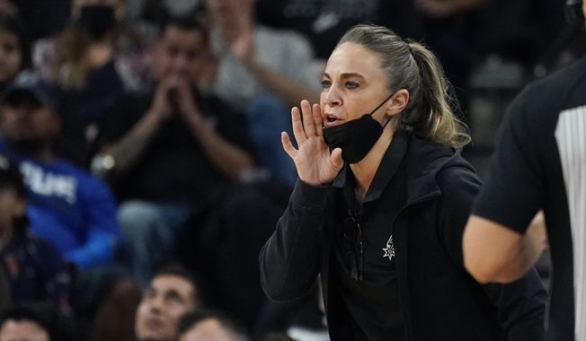San Antonio Spurs assistant coach Becky Hammon during the first half of an NBA basketball game against the Dallas Mavericks, Friday, Nov. 12, 2021, in San Antonio.  Hammon is finalizing a deal to become the next coach of the Las Vegas Aces. A person familiar with the situation confirmed the move to The Associated Press on condition of anonymity because no official announcement has been made. She’s expected to be the highest paid coach in the WNBA, earning way more than the highest paid player in the league.   (AP Photo/Eric Gay, File)  **FILE**