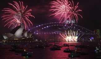 Fireworks explode over the Sydney Opera House and Harbour Bridge as New Year&#39;s Eve celebrations begin in Sydney, Friday, Dec. 31, 2021. (Dean Lewins/AAP Image via AP)