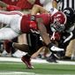 Alabama&#39;s Brian Robinson Jr. (4) is tackled by Cincinnati&#39;s Bryan Cook during the first half of the Cotton Bowl NCAA College Football Playoff semifinal game, Friday, Dec. 31, 2021, in Arlington, Texas. (AP Photo/Michael Ainsworth)
