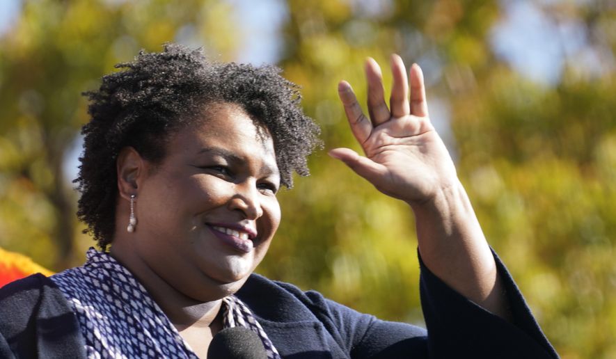 Stacey Abrams speaks to Biden supporters as they wait for former President Barack Obama to arrive and speak at a campaign rally for Biden at Turner Field in Atlanta, Nov. 2, 2020. (AP Photo/Brynn Anderson, File)
