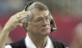 In this file photo, Atlanta Falcons coach Dan Reeves adjusts his headset at the start of play against the Detroit Lions at the Georgia Dome in Atlanta Sunday, Dec. 22, 2002.  Reeves, who won a Super Bowl as a player with the Dallas Cowboys but was best known for a long coaching career highlighted by four more appearances in the title game with the Denver Broncos and Atlanta Falcons, died Saturday, Jan. 1, 2022.   (AP Photo/Ric Feld, File)  **FILE**