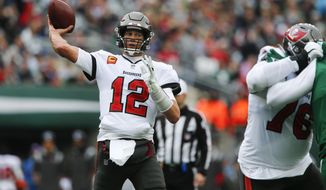 Tampa Bay Buccaneers quarterback Tom Brady, left, throws during the first half of an NFL football game against the New York Jets, Sunday, Jan. 2, 2022, in East Rutherford, N.J. (AP Photo/John Munson)