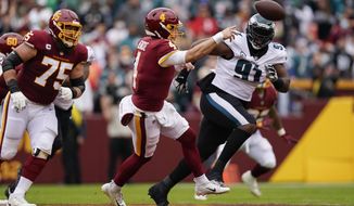 Washington Football Team quarterback Taylor Heinicke (4) pass the ball while under pressure from Philadelphia Eagles during the first half of an NFL football game, Sunday, Jan. 2, 2022, in Landover, Md. (AP Photo/Al Drago)