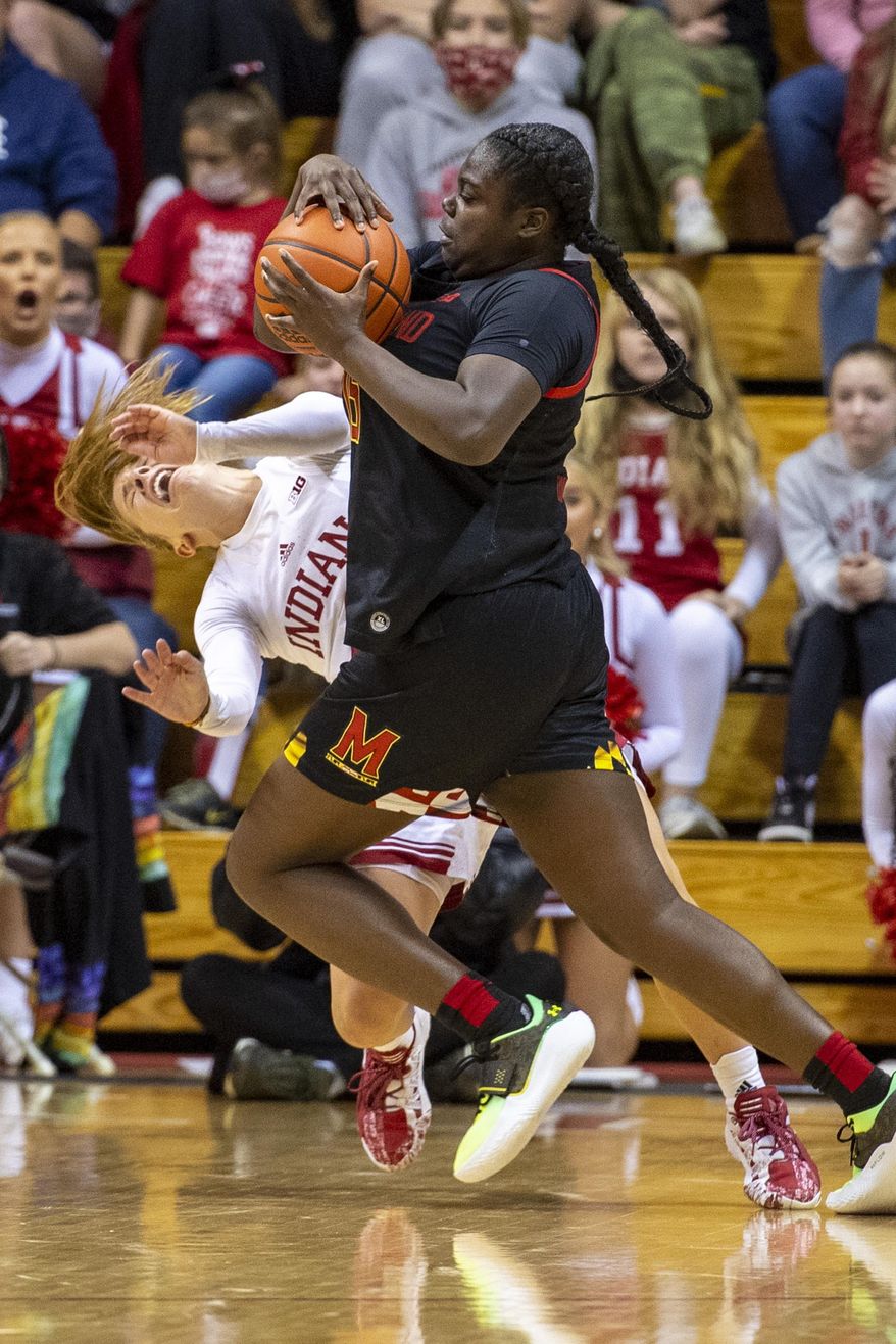 Maryland guard Ashley Owusu (15) collides with Indiana guard Nicole Cardano-Hillary (4) en route to the basket during the second half of an NCAA college basketball game, Sunday, Jan. 2, 2022, in Bloomington, Ind. (AP Photo/Doug McSchooler)