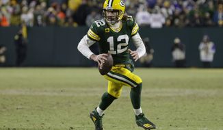 Green Bay Packers&#x27; Aaron Rodgers runs for a first down during the second half of an NFL football game against the Minnesota Vikings Sunday, Jan. 2, 2022, in Green Bay, Wis. (AP Photo/Matt Ludtke)