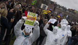 Several thousands of people defied a ban Sunday to gather and protest the Dutch government&#39;s coronavirus lockdown measures, in Amsterdam, Netherlands, Sunday, Jan. 2, 2022. The municipality of the Dutch capital banned the protest, saying police had indications some demonstrators could be attending &amp;quot;prepared for violence.&amp;quot; (AP Photo/Peter Dejong)