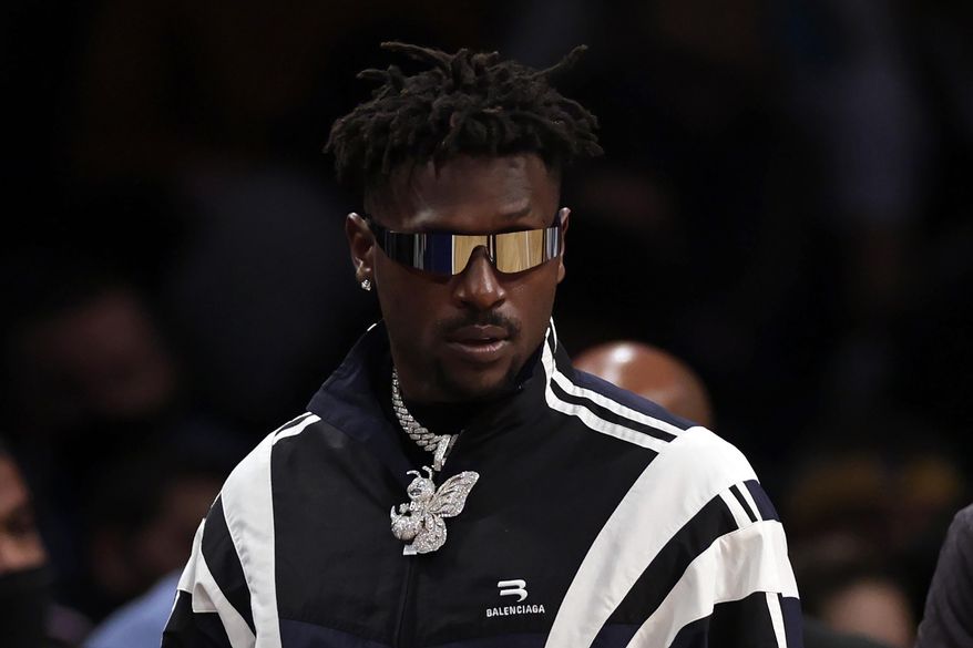 Former Tampa Bay Buccaneers wide receiver Antonio Brown arrives courtside during the second half of an NBA basketball game between the Memphis Grizzlies and the Brooklyn Nets, Monday, Jan. 3, 2022, in New York. (AP Photo/Adam Hunger)