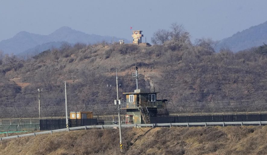 FILE - Military guard posts of North Korea, rear, and South Korea, front, are seen in Paju, near the border with North Korea, South Korea, Sunday, Jan. 2, 2022. A person who crossed the border into North Korea on New Year’s Day was likely a defector who had slipped through the same heavily fortified frontier in the other direction for a settlement in South Korea in late 2020, South Korea’s military said Monday. (AP Photo/Ahn Young-joon, File)