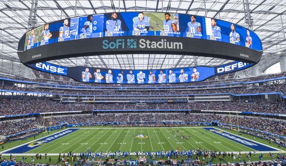 This is a general overall interior view of SoFi Stadium as the Los Angeles Rams takes on the Tampa Bay Buccaneers in an NFL football game Sunday, Sept. 26, 2021, in Inglewood, Calif. A late-season surge in COVID-19 cases had the NFL in 2021 looking a lot like 2020, when the coronavirus led to significant disruptions, postponements and changing protocols. The emerging omicron variant figures to play a role all the way through the playoffs, including the Super Bowl in Los Angeles, where California has always been aggressive with policies to combat the spread of the virus. (AP Photo/Kyusung Gong, File) **FILE**