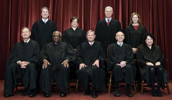 Members of the Supreme Court pose for a group photo at the Supreme Court in Washington, April 23, 2021. Seated from left are Associate Justice Samuel Alito, Associate Justice Clarence Thomas, Chief Justice John Roberts, Associate Justice Stephen Breyer and Associate Justice Sonia Sotomayor, Standing from left are Associate Justice Brett Kavanaugh, Associate Justice Elena Kagan, Associate Justice Neil Gorsuch and Associate Justice Amy Coney Barrett. (Erin Schaff/The New York Times via AP, Pool, File)