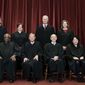 Members of the Supreme Court pose for a group photo at the Supreme Court in Washington, April 23, 2021. Seated from left are Associate Justice Samuel Alito, Associate Justice Clarence Thomas, Chief Justice John Roberts, Associate Justice Stephen Breyer and Associate Justice Sonia Sotomayor, Standing from left are Associate Justice Brett Kavanaugh, Associate Justice Elena Kagan, Associate Justice Neil Gorsuch and Associate Justice Amy Coney Barrett. The Supreme Court is refusing to say whether the nine justices have received COVID-19 vaccination booster shots, with the omicron variant surging and in-person arguments over vaccines scheduled at the court on Friday, Jan. 7, 2022. (Erin Schaff/The New York Times via AP, Pool, File)