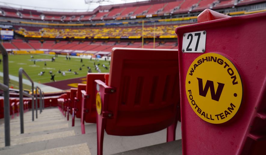 Seats at Fedex Field display the Washington Football Team logo during pregame warmups of an NFL football game between Washington Football Team and Philadelphia Eagles, in Landover, Md., Sunday, Sept. 13, 2020. Washington’s NFL team said Tuesday, Jan. 4, 2022, it will unveil its new name on Feb. 2. Team president Jason Wright confirmed that the name will not be Wolves or RedWolves. He cited trademark challenges for not going down that path that was popular among fans.(AP Photo/Susan Walsh) **FILE**