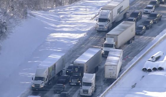 Motorists sit stranded on Interstate 95 in Northern, Va., on Tuesday, Jan. 4, 2022. Hundreds of motorists were stranded all night in snow and freezing temperatures along a 50-mile stretch of Interstate 95 after a crash involving six tractor-trailers in Virginia, where authorities were struggling Tuesday to reach them.  (WJLA via AP)