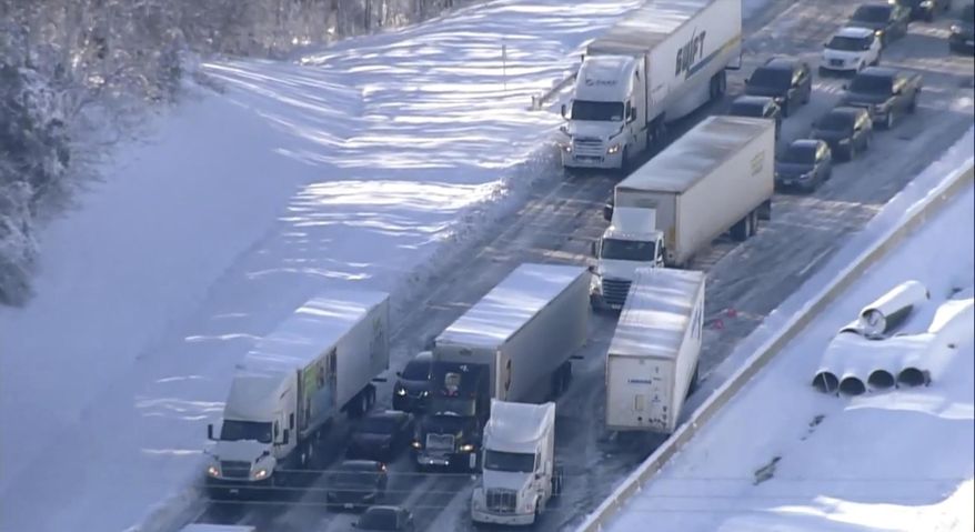 Motorists sit stranded on Interstate 95 in Northern, Va., on Tuesday, Jan. 4, 2022. Hundreds of motorists were stranded all night in snow and freezing temperatures along a 50-mile stretch of Interstate 95 after a crash involving six tractor-trailers in Virginia, where authorities were struggling Tuesday to reach them. (WJLA via AP)