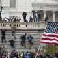 Rioters scale a wall at the U.S. Capitol on Jan. 6, 2021, in Washington. (AP Photo/Jose Luis Magana)  **FILE**