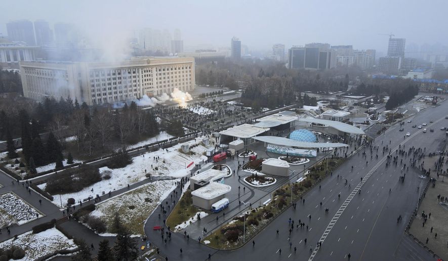 Smoke rises from the city hall building during a protest in Almaty, Kazakhstan, Wednesday, Jan. 5, 2022. News outlets in Kazakhstan are reporting that demonstrators protesting rising fuel prices broke into the mayor&#39;s office in the country&#39;s largest city and flames were seen coming from inside. Kazakh news site Zakon said many of the demonstrators who converged on the building in Almaty on Wednesday carried clubs and shields. (AP Photo/Yan Blagov)