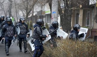 Riot police walk to block demonstrators during a protest in Almaty, Kazakhstan, Wednesday, Jan. 5, 2022. Demonstrators denouncing the doubling of prices for liquefied gas have clashed with police in Kazakhstan&#39;s largest city and held protests in about a dozen other cities in the country. (AP Photo/Vladimir Tretyakov)