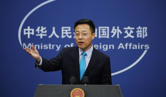 In this file photo, Chinese Foreign Ministry spokesman Zhao Lijian gestures as he speaks during a daily briefing at his ministry in Beijing, Feb. 24, 2020. Taiwan says it&#39;s creating an investment fund and planning other measures to help Lithuania as it faces major economic pressure from China for allowing the island to open a representative office in the European Union country. Taiwanese officials said Wednesday, Jan. 5, 2021 that the $200 million fund would help key Lithuanian industries. Chinese foreign ministry spokesman Zhao Lijian has called it “false news” that Beijing has blocked Lithuanian imports or pressured multinational companies that do business with the EU country. (AP Photo/Andy Wong, file)  **FILE**