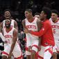 Houston Rockets&#39; Kevin Porter Jr., front second from right in front, celebrates with his teammates after making the game-winning 3-point shot in the team&#39;s NBA basketball game against the Washington Wizards, Wednesday, Jan. 5, 2022, in Washington. (AP Photo/Luis M. Alvarez) **FILE**
