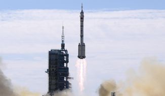 FILE - A Long March-2F Y12 rocket carrying a crew of Chinese astronauts in a Shenzhou-12 spaceship lifts off at the Jiuquan Satellite Launch Center in Jiuquan in northwestern China, Thursday, June 17, 2021. China has recommitted itself to completing its orbiting space station by the end of the year and says it is planning more than 40 launches for 2022, putting it roughly level with the United States. (AP Photo/Ng Han Guan, File)