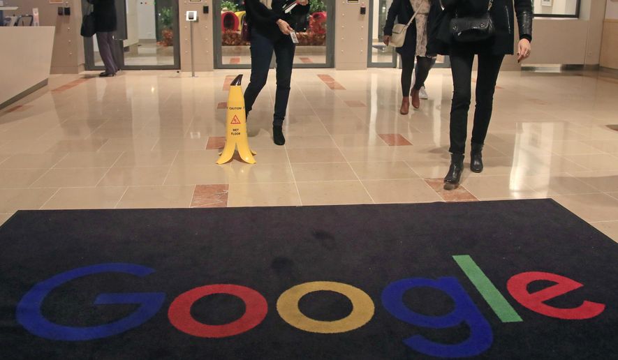 FILE - In this file photo dated Nov. 18, 2019, Google employees walks out of Google France building in Paris. France. French regulators on Thursday fined Google and Facebook a total of more than 200 million euros ($226 million) for not making it as easy for users to opt out of tracking as it is for them to accept it.  (AP Photo/Michel Euler, File)
