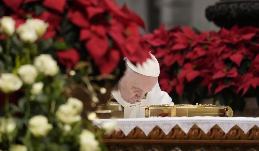 Pope Francis bows on the altar as he celebrates an Epiphany mass in St. Peter&#x27;s Basilica, at the Vatican, Thursday, Jan. 6, 2022. (AP Photo/Gregorio Borgia)