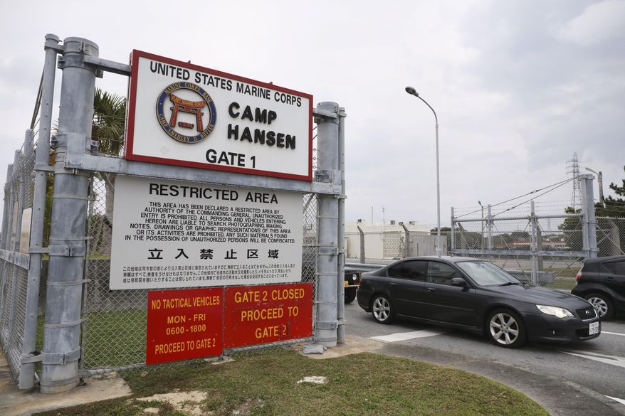 A vehicle leaves the U.S. Marine Corps&#39; Camp Hansen, in Kin, Okinawa prefecture, southern Japan, on Jan. 5, 2022. The U.S. military on Thursday, Jan. 6, ordered personnel stationed in Japan to wear masks when going off base to curb the spread of COVID-19 infections.  (Kyodo News via AP)