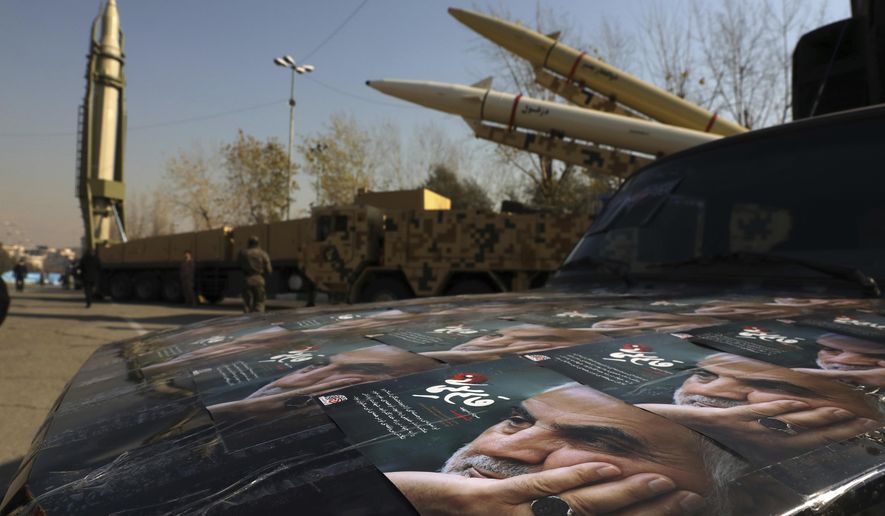 Posters of Iranian Gen. Qassem Soleimani, who was killed in Iraq in a U.S. drone attack in Jan. 3, 2020, are seen in front of Qiam, background left, Zolfaghar, top right, and Dezful missiles displayed in a missile capabilities exhibition by the paramilitary Revolutionary Guard a day prior to second anniversary of Iran&#x27;s missile strike on U.S. bases in Iraq in retaliation for killing Gen. Soleimani, at Imam Khomeini grand mosque, in Tehran, Iran, Friday, Jan. 7, 2022. Iran put three ballistic missiles on display on Friday, as talks in Vienna aimed at reviving Tehran&#x27;s nuclear deal with world powers flounder. (AP Photo/Vahid Salemi) **FILE**