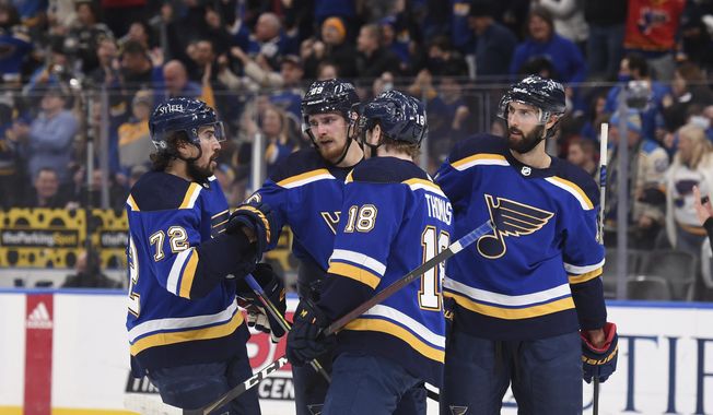 St. Louis Blues left wing Pavel Buchnevich, second from left, is congratulated after his goal against the Washington Capitals during the third period of an NHL hockey game Friday, Jan. 7, 2022, in St. Louis. (AP Photo/Joe Puetz)