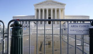 The Supreme Court shown Friday, Jan. 7, 2022, in Washington. The Supreme Court is taking up two major Biden administration efforts to bump up the nation&#39;s vaccination rate against COVID-19 at a time of spiking coronavirus cases because of the omicron variant. (AP Photo/Evan Vucci)