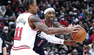 Washington Wizards guard Kentavious Caldwell-Pope, right, and Chicago Bulls forward DeMar DeRozan battle for the ball during the first half of an NBA basketball game in Chicago, Friday, Jan. 7, 2022. (AP Photo/Nam Y. Huh)