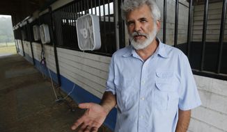 Dr. Robert Malone gestures as he stands in his barn, Wednesday July 22, 2020, in Madison, Va.  An unfounded theory taking root online suggests millions of people have been “hypnotized” into believing mainstream ideas about COVID-19.  In widely shared social media posts this week, efforts to combat the disease have been dismissed with just three words: “mass formation psychosis.”  The term gained attention after it was floated by Malone during a Dec. 31, 2021 appearance on a podcast.(AP Photo/Steve Helber)