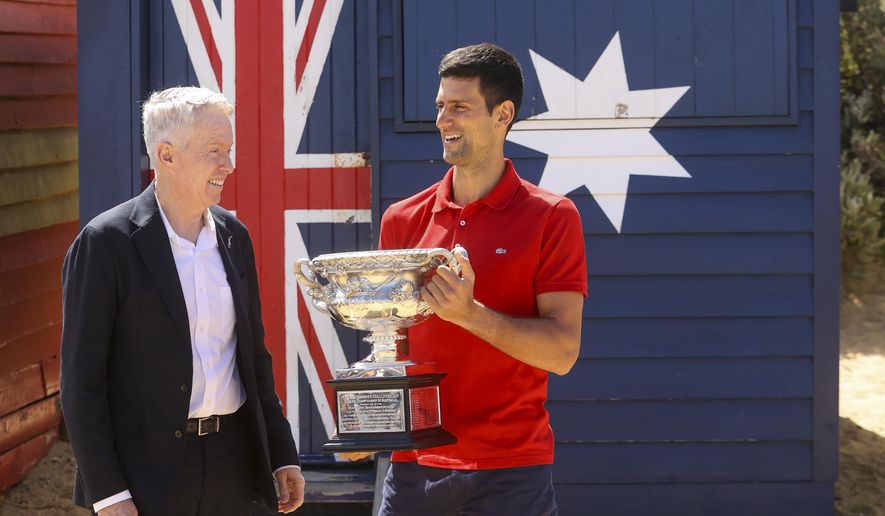 Serbia&#39;s Novak Djokovic, right, stands with Australian Open tournament director Craig Tiley for a trophy photo shoot following his win the Australian Open tennis championships in Melbourne, Australia, Monday, Feb 22, 2021. The No. 1-ranked Djokovic was denied entry at the Melbourne airport late Wednesday, Jan 5, 2022, after border officials canceled his visa for failing to meet its entry requirement that all noncitizens be fully vaccinated for COVID-19. (AP Photo/Hamish Blair) ** FILE **