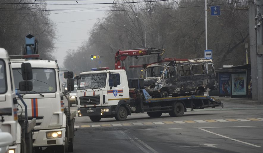 A tow truck transports a bus, which was burned during clashes in Almaty, Kazakhstan, Sunday, Jan. 9, 2022. Kazakhstan&#x27;s health ministry says 164 people have been killed in protests that have rocked the country over the past week. President Kassym-Jomart Tokayev&#x27;s office said Sunday that order has stabilized in the country and that authorities have regained control of administrative buildings that were occupied by protesters, some of which were set on fire. (Vladimir Tretyakov/NUR.KZ via AP)