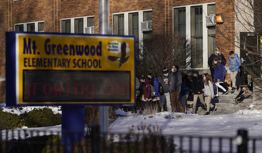 Students at the Mt. Greenwood Elementary School in Chicago depart after a full day of classes on Monday, Jan. 10, 2022. As hundreds of thousands of Chicago students remained out of school for a fourth day, students at the South Side school were back in classes as the school had enough staff to defy the union&#39;s directive to teachers to stay home amid negotiations with the school district over COVID-19 safety protocols. (AP Photo/Charles Rex Arbogast)