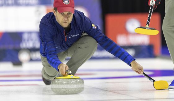FILE - Team Shuster&#39;s John Shuster slides the stone while competing against Team Dropkin at the U.S. Olympic Curling Team Trials at Baxter Arena in Omaha, Neb., Wednesday, Nov. 17, 2021. The five-time Olympian is back to defend his curling gold medal in Beijing, and the target on his back will be almost as big as the one on the ice. (AP Photo/Rebecca S. Gratz, File)