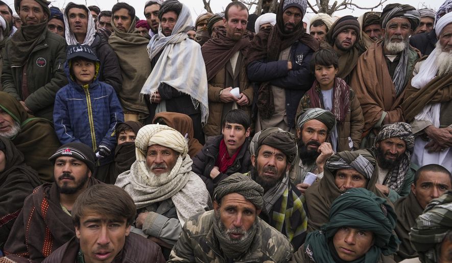 Hundreds of Afghan men gather to apply for the humanitarian aid in Qala-e-Naw, Afghanistan, Tuesday, Dec. 14, 2021. In a statement Tuesday, Jan. 11, 2022, the White House announced $308 million in additional humanitarian assistance for Afghanistan, offering new aid to the country as it edges toward a humanitarian crisis since the Taliban takeover nearly five months earlier. (AP Photo/Mstyslav Chernov, File)