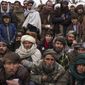 Hundreds of Afghan men gather to apply for the humanitarian aid in Qala-e-Naw, Afghanistan, Tuesday, Dec. 14, 2021. In a statement Tuesday, Jan. 11, 2022, the White House announced $308 million in additional humanitarian assistance for Afghanistan, offering new aid to the country as it edges toward a humanitarian crisis since the Taliban takeover nearly five months earlier. (AP Photo/Mstyslav Chernov, File)