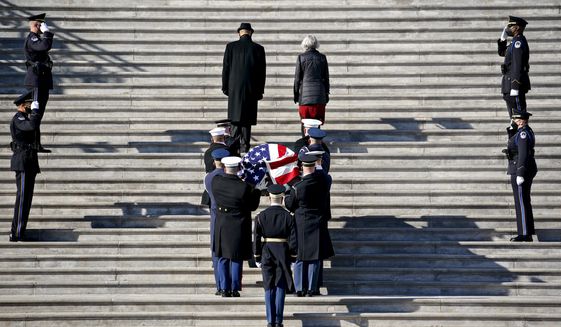 The flag-draped casket of the late Sen. Harry Reid, D-Nev., arrives at the U.S. Capitol where he will lie in state, Wednesday, Jan. 12, 2022 in Washington.  Reid, who served five terms in the Senate, will be honored Wednesday in the Capitol Rotunda during a ceremony closed to the public under COVID-19 protocols. (Al Drago/Pool via AP)