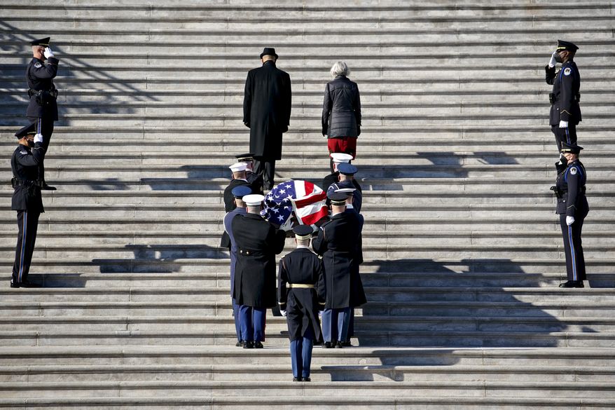 The flag-draped casket of the late Sen. Harry Reid, D-Nev., arrives at the U.S. Capitol where he will lie in state, Wednesday, Jan. 12, 2022 in Washington.  Reid, who served five terms in the Senate, will be honored Wednesday in the Capitol Rotunda during a ceremony closed to the public under COVID-19 protocols. (Al Drago/Pool via AP)