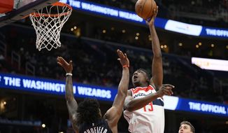Washington Wizards center Thomas Bryant (13) shoots over Orlando Magic forward Admiral Schofield (25) during the second half of an NBA basketball game, Wednesday, Jan. 12, 2022, in Washington. The Wizards won 112-106. (AP Photo/Nick Wass)