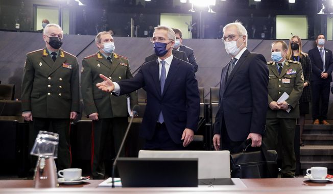 NATO Secretary-General Jens Stoltenberg, center, and Russia&#x27;s Deputy Foreign Minister Alexander Grushko, fourth right, arrive for the NATO-Russia Council at NATO headquarters, in Brussels, Wednesday, Jan. 12, 2022. (Olivier Hoslet, Pool Photo via AP)